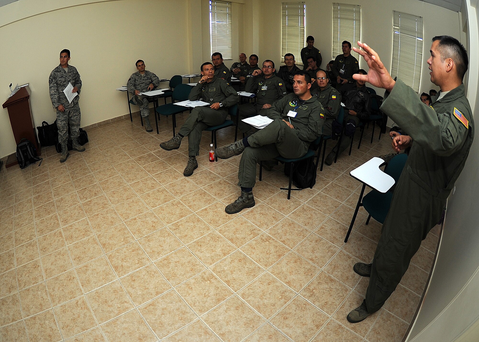 Staff Sgt. Peter Salinas (left), 571st Mobility Support Advisory Squadron air transportation air advisor, looks on as Staff Sgt. Javier Borges, 571st MSAS loadmaster air advisor, explains the joint inspection form during the second day of seminars June 6 at Commando Aéreo de Transporte Militar, Bogota, Colombia.  (U.S. Air Force photo by Tech. Sgt. Lesley Waters)