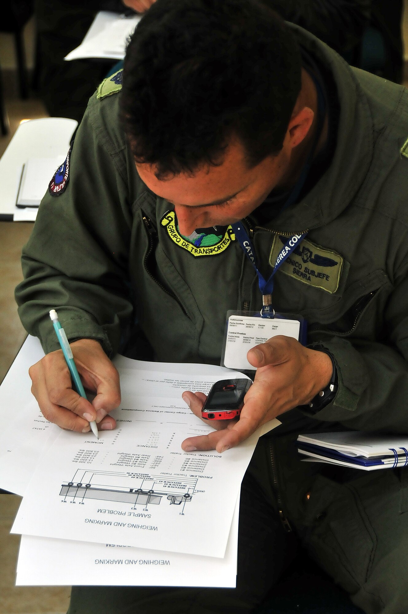 Técnico Subjefe Hector Sierra, Colombian air force member, completes the center of balance handout during a seminar June 6 at Commando Aéreo de Transporte Militar, Bogota, Colombia.  (U.S. Air Force photo by Tech. Sgt. Lesley Waters)