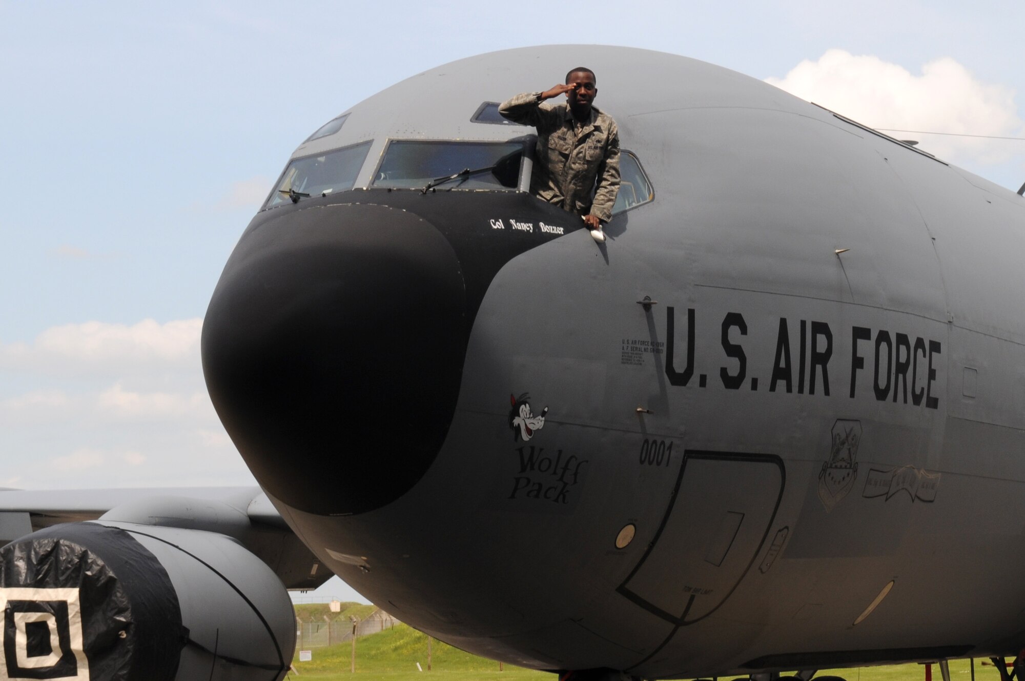 RAF MILDENHALL, England – Staff Sgt. Sherwin Allen, 100th Aircraft Maintenance Squadron KC-135 Stratotanker dedicated crew chief, salutes Col. Nancy Bozzer, 100th Operations Group commander, after revealing the colonel’s name on her flagship aircraft at the 100th OG change of command June 14, 2012, in Hangar 814. Bozzer assumed command from Col. William DeMarco. (U.S. Air Force photo/Senior Airman Rachel Waller)