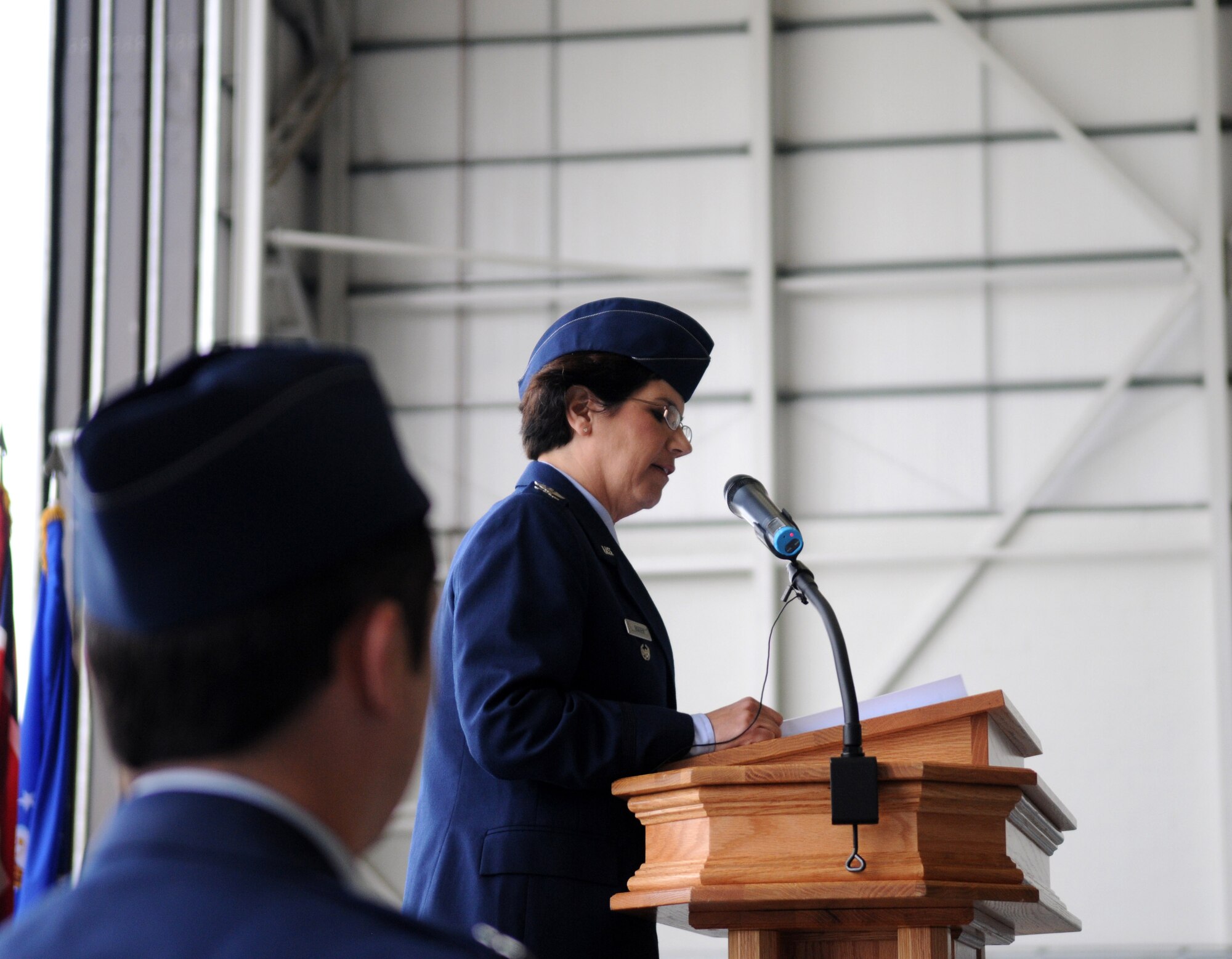 RAF MILDENHALL, England –  A 100th Operations Group Airman listens as Col. Nancy Bozzer, newly appointed 100th Operations Group commander, addresses the group at the 100th OG change-of-command ceremony June 14, 2012, at Hangar 814. Bozzer assumed command from Col. William DeMarco. (U.S. Air Force photo/Senior Airman Rachel Waller)