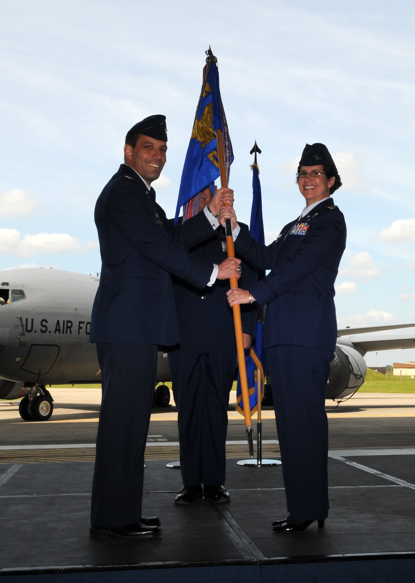 RAF MILDENHALL, England – Col. Nancy Bozzer accepts the 100th Operations Group guidon from Col. Christopher Kulas, 100th Air Refueling Wing commander, signifying her formal acceptance of command over the 100th OG during a change-of-command ceremony June 14, 2012, at Hangar 814. Bozzer previously served as the deputy chief of bases and forces division, Ramstein Air Base, Germany. (U.S. Air Force photo/Senior Airman Rachel Waller)