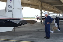 Steve Kelly (left) and Mike Lloyd, 902nd Civil Engineer Squadron entomology section, prepare to remove a swarm of bees on the flap of a T-6 Texan II aircraft on the flightline at Joint Base San Antonio-Randolph, Texas, June 13. (U.S. Air Force photo by Rich McFadden) 