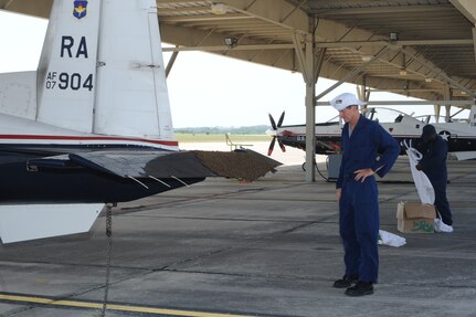 Steve Kelly (left) and Mike Lloyd, 902nd Civil Engineer Squadron entomology section, prepare to remove a swarm of bees on the flap of a T-6 Texan II aircraft on the flightline at Joint Base San Antonio-Randolph, Texas, June 13. (U.S. Air Force photo by Rich McFadden) 