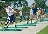 Garrett Anders hits practice balls at the Joint Base San Antonio-Randolph Oaks driving range June 13 during the annual Junior Golf Clinic at JBSA-Randolph, Texas. (U.S. Air Force photo by Benjamin Faske)