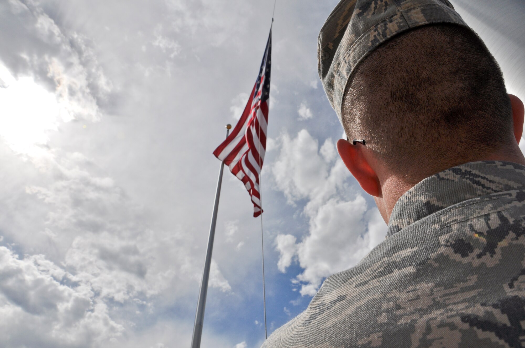 BUCKLEY AIR FORCE, Colo. -- Senior Airman Brett Steffen, 460th Comptroller Squadron customer service technician, raises the American flag at the 460th Space Wing Headquarters building.  Steffen raises and lowers the flag for ceremonies, weather and other occasions all while paying Old Glory the proper respects. (U.S. Air Force photo by Staff Sgt. Nicholas Rau)