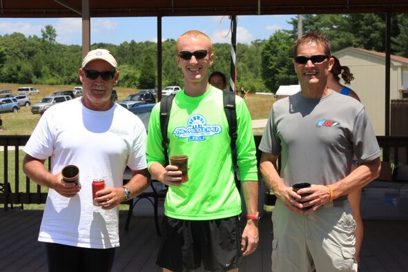 From left, Bill Gray (former 704th Test Systems Group director), 1st Lt. Brad Chronister, AEDC Investments Branch specialist, and Kevin Sipe, AEDC’s Capability Integration Branch specialist, pose with their awards as winners of the relay competition of the 2012 Mach Tenn Triathlon. Chronister clocked an unofficial record-setting 19:24 for the hilly, four-mile run. (Photo provided)