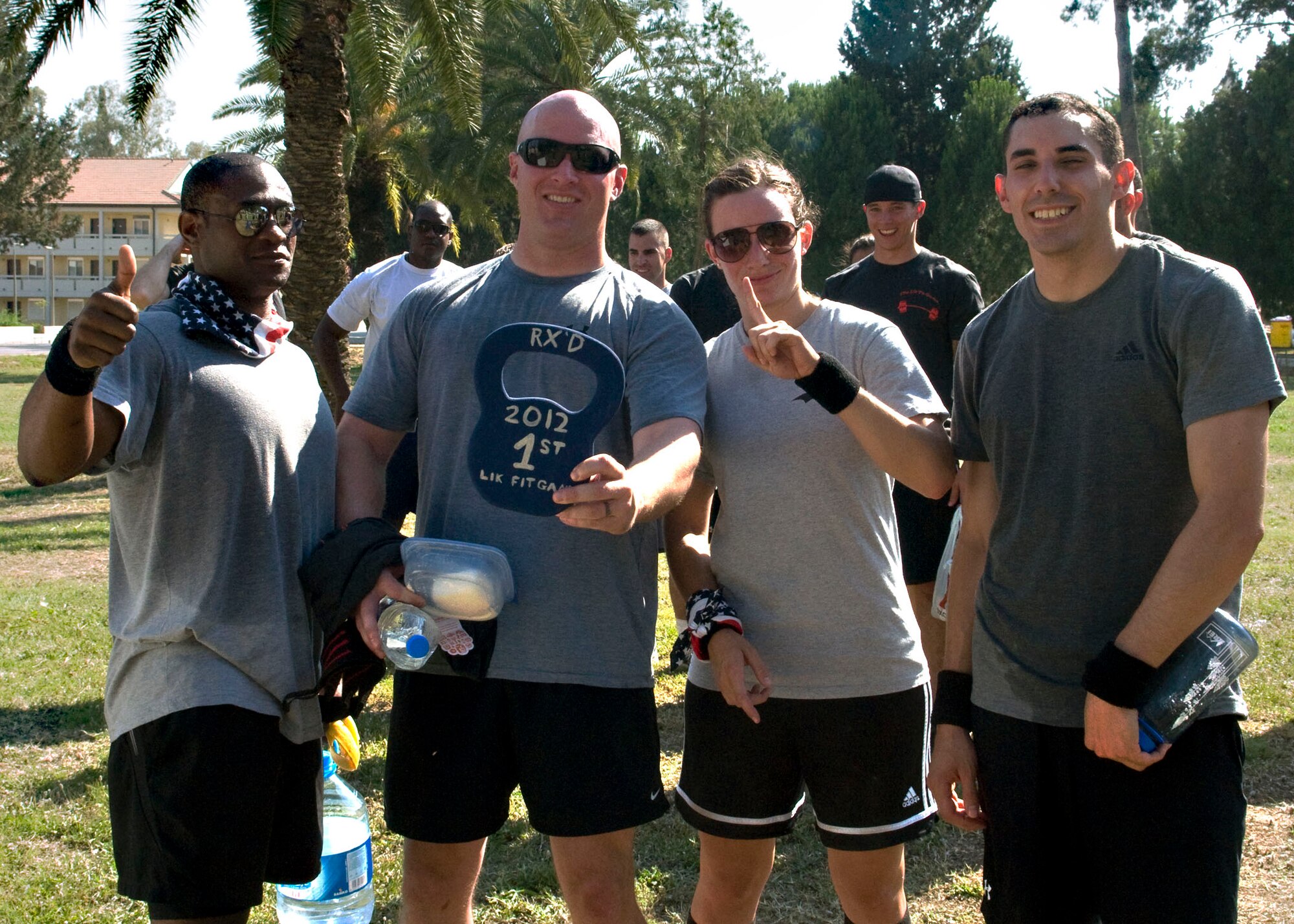 Team Awesome America strikes victory poses after winning first place in the 'Lik Fit games June 8, 2012, at Incirlik Air Base, Turkey. The fit games were sponsored by the fitness center and were designed to test participant's physical strength and endurance. (U.S. Air Force photo by Senior Airman Marissa Tucker/Released)