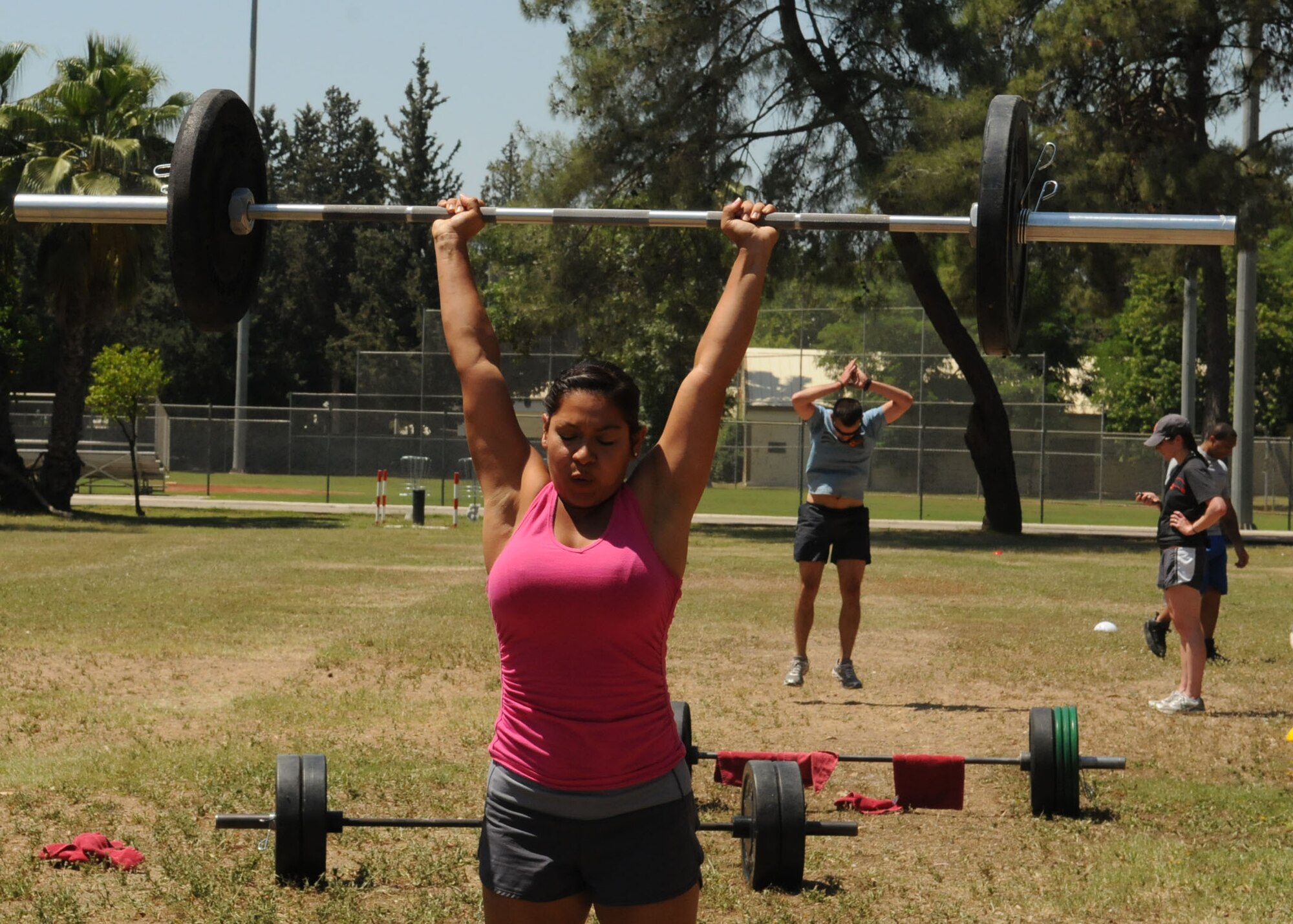 Karla Alexander, a fitness instructor at the fitness center, completes an overhead lift during the 'Lik Fit Games June 8, 2012, at Incirlik Air Base, Turkey.
Four teams participated in the fit games, which included three different courses with exercises designed to test participants physical fitness levels while building camaraderie through competition. (U.S. Air Force photo by Senior Airman Marissa Tucker/Released)

