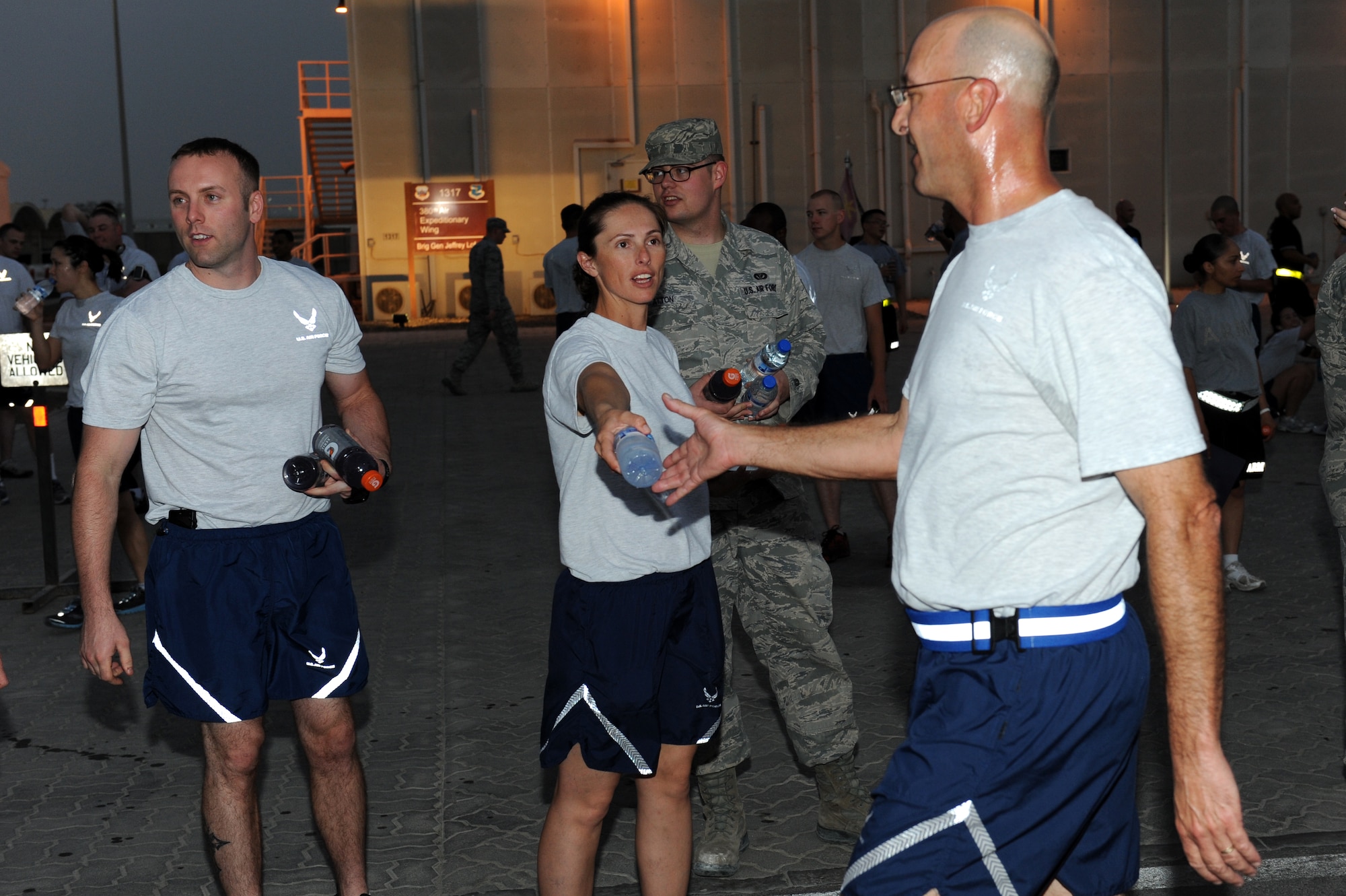 SOUTHWEST ASIA - Airmen volunteers hand out water and sports drinks at the end of the U.S. Army's 5K birthday run/ruck march at the 380th Air Expeditionary Wing June 14, 2012. The event was held to celebrate the U.S. Army's 237th birthday. (U.S. Air Force photo/Master Sgt. Scott MacKay)