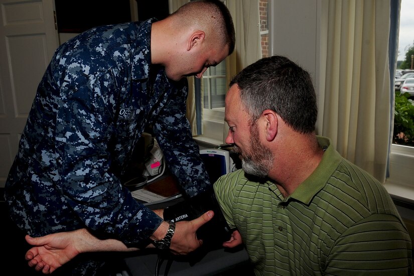 U.S. Navy Seaman Calvin Koffman, Portsmouth Naval Center hospitalman, takes the blood pressure of John Meyers, Air Combat Command training manager, during a blood drive at Langley Air Force Base, Va., June 12, 2012. The Armed Forces Blood Program has a local station at Portsmouth Naval Medical Center, which provides mobile centers to surrounding bases. (U.S. Air Force photo by Staff Sgt. Ashley Hawkins/Released)