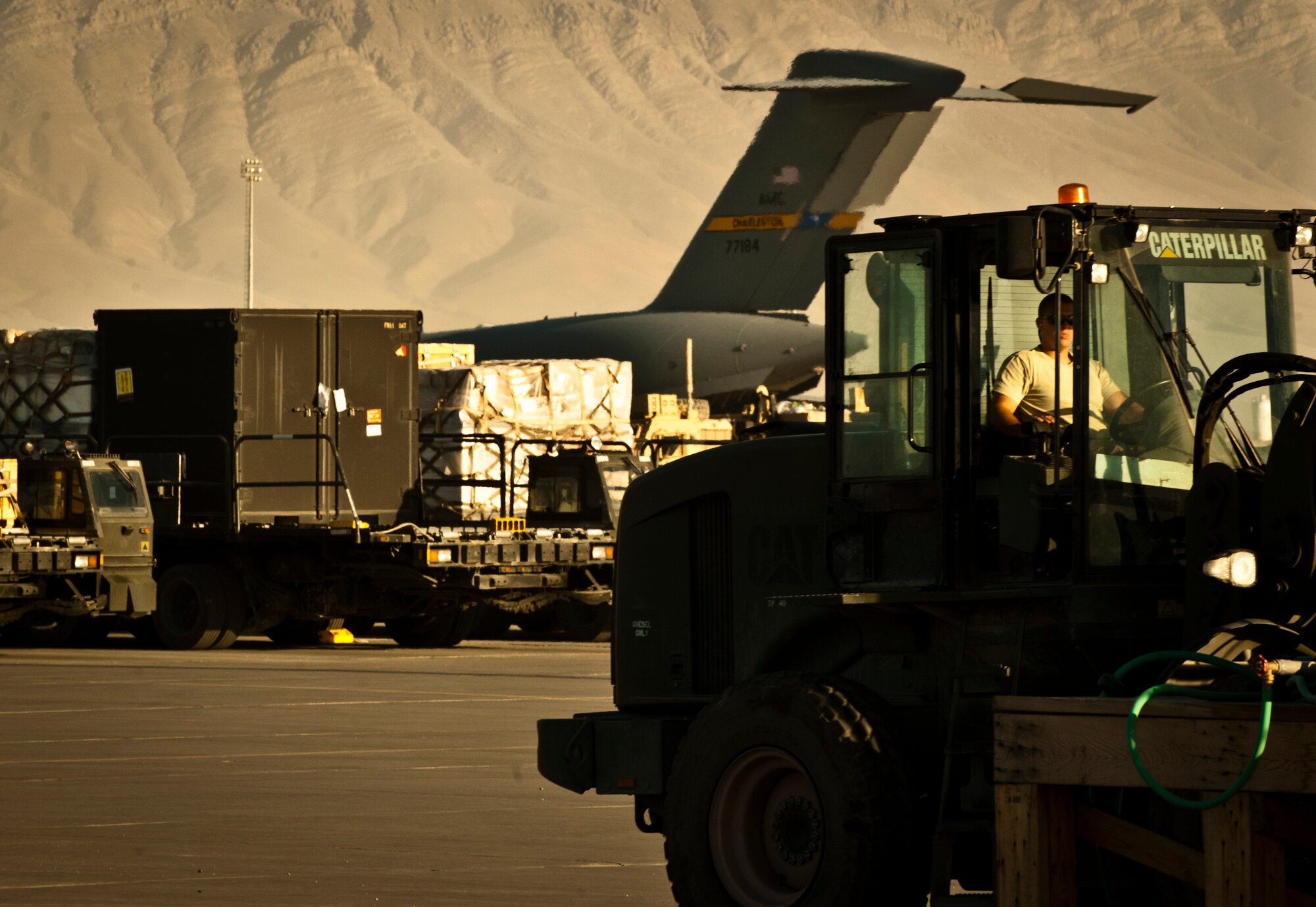 An Airman assigned to the 455th Expeditionary Aerial Port Squadron, moves cargo with a 10K all-terrain forklift in the cargo yard at Bagram Airfield, Afghanistan, June 8, 2012. Every day, personnel with 455 EAPS process more than 1 million pounds of cargo in support of U.S. and Coalition forces operating in Afghanistan. (U.S. Air Force photo/Capt. Raymond Geoffroy)