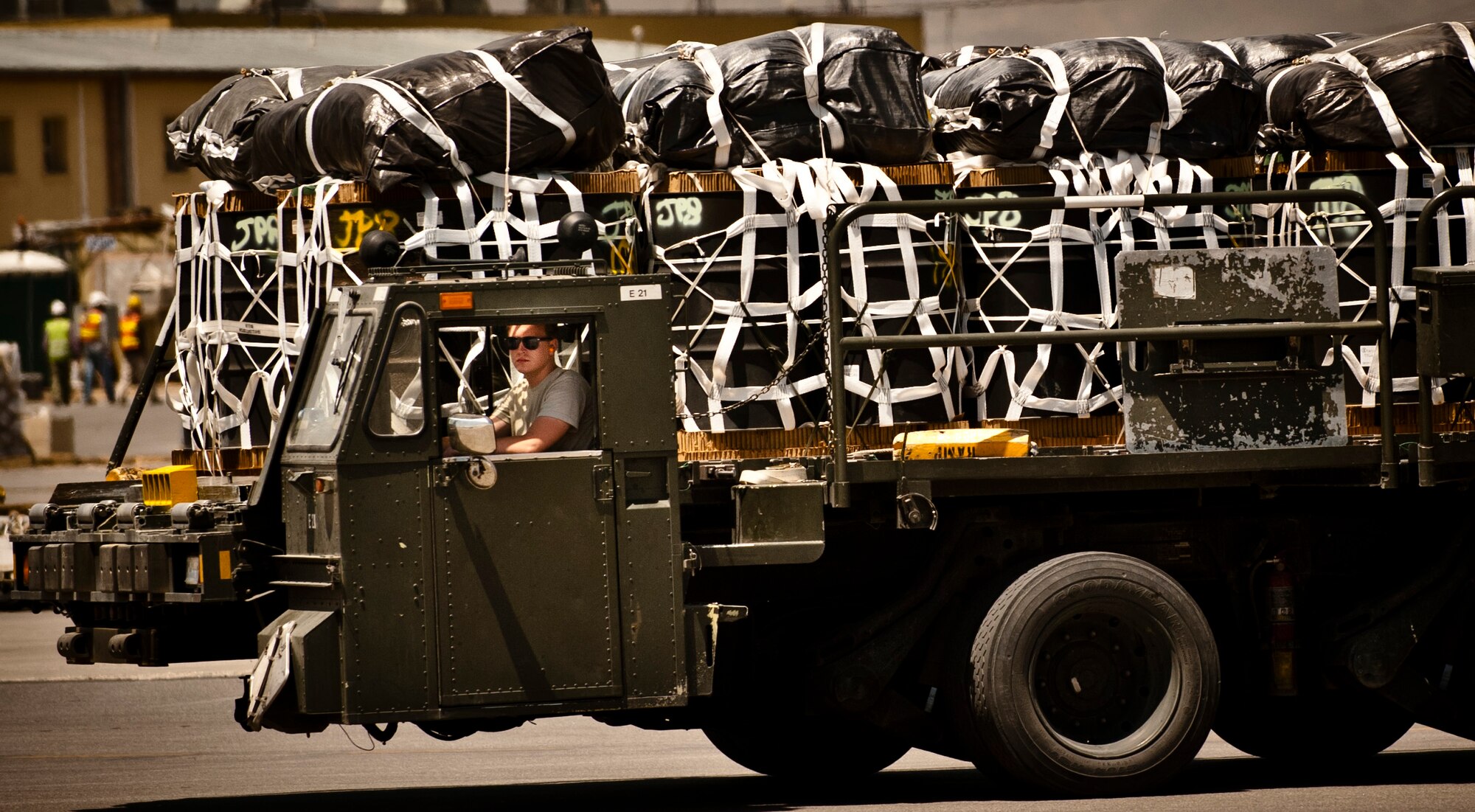 An Airman assigned to the 455th Expeditionary Aerial Port Squadron drives a 10K front-loader full of cargo to an awaiting aircraft at Bagram Airfield, Afghanistan, June 8, 2012. Every day, personnel with 455 EAPS process more than one million pounds of cargo in support of U.S. and Coalition forces operating in Afghanistan. (U.S. Air Force photo/Capt. Raymond Geoffroy)