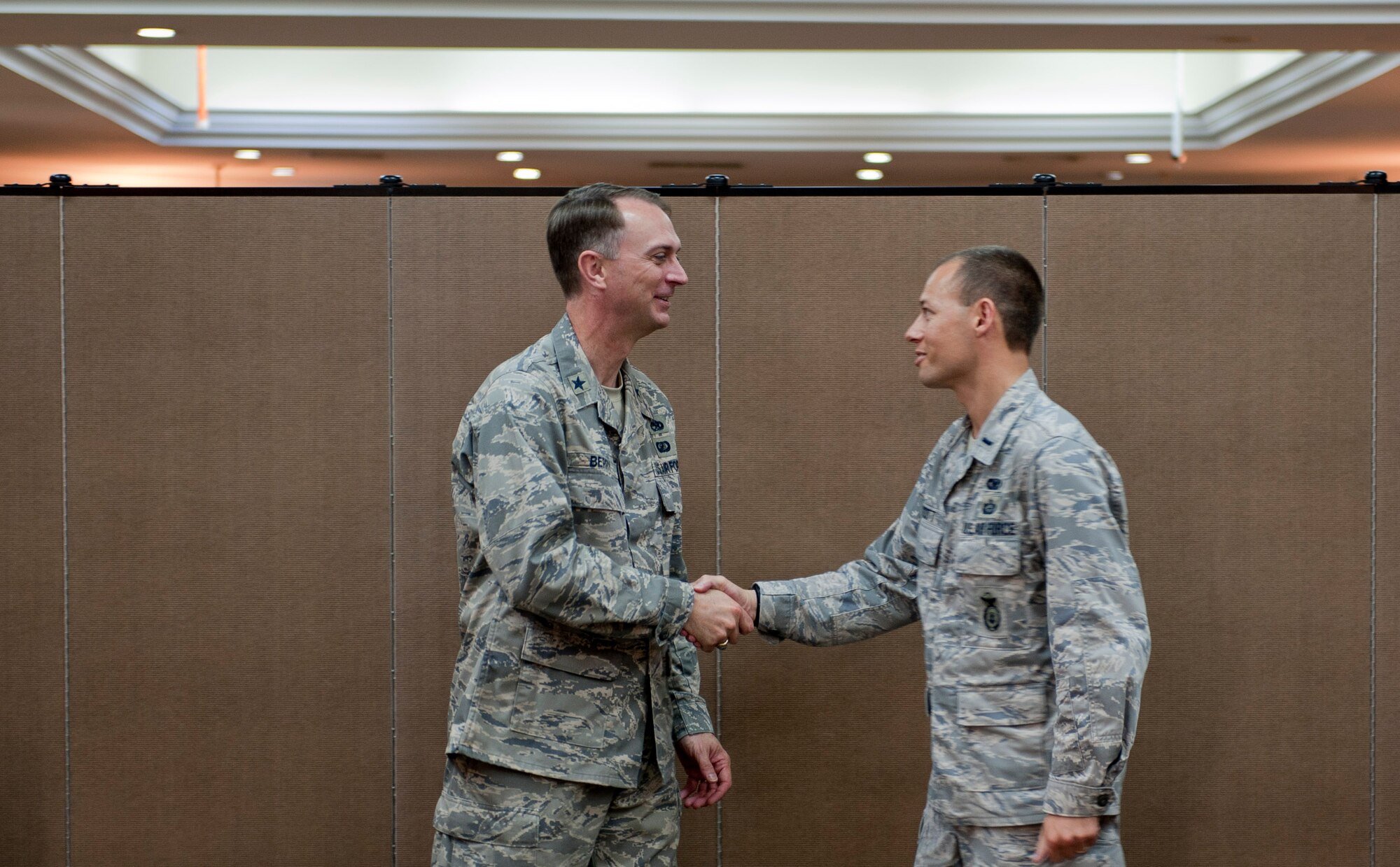 Brig. Gen. Warren D. Berry, Director of Logistics, Installations and Mission Support, Headquarters U.S. Air Forces in Europe, Ramstein Air Base, Germany, left, receives a coin from 1st. Lt. James Scott, 39th Security Forces Squadron officer in charge of logistics and resources, and the company grade officer council president, after a leadership seminar breakfast June 13, 2012, at Incirlik Air Base, Turkey. Berry discussed several topics and emphasized the importance of networking, making what you do matter and appreciating those who have helped you succeed. (U.S. Air Force photo by Senior Airman Anthony Sanchelli/Released) 
