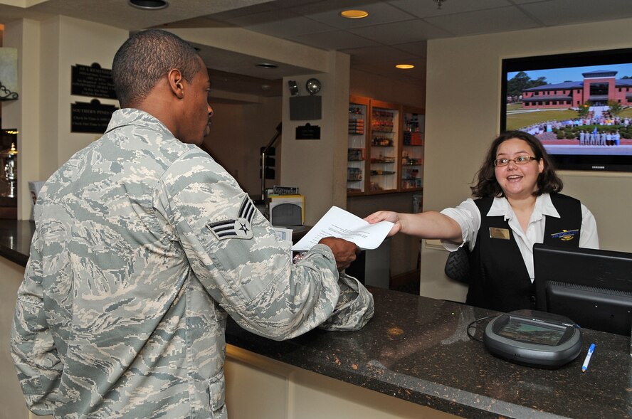 U.S. Air Force Senior Airman Brent Kilgoe receives a receipt from Michelle Davidson after his stay at the Southern Pines Inn on Seymour Johnson Air Force Base, N.C., June 13, 2012. Kilgoe, 916th Aircraft Maintenance Unit hydraulics maintainer, hails from High Point, N.C. Michelle, 4th Force Support Squadron lodging customer service representative, is the spouse of Staff Sgt. Steven Davidson, 333rd Aircraft Maintenance Unit weapons loader, and hails from Hoxie, Ark. (U.S. Air Force photo/Airman 1st Class Aubrey Robinson/Released)