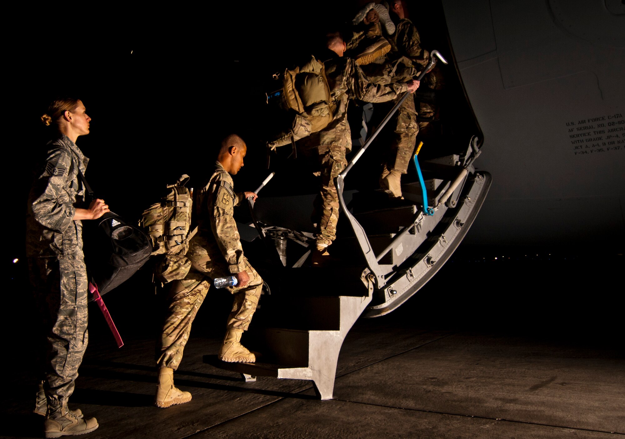 U.S. Service Members climb aboard a U.S. Air Force C-17 Globemaster III at Bagram Airfield, Afghanistan, June 6, 2012, after completing their tour of duty. The troops returned to their home stations with the help of the Airmen of the 455th Expeditionary Aerial Port Squadron. (U.S. Air Force photo/Capt. Raymond Geoffroy)