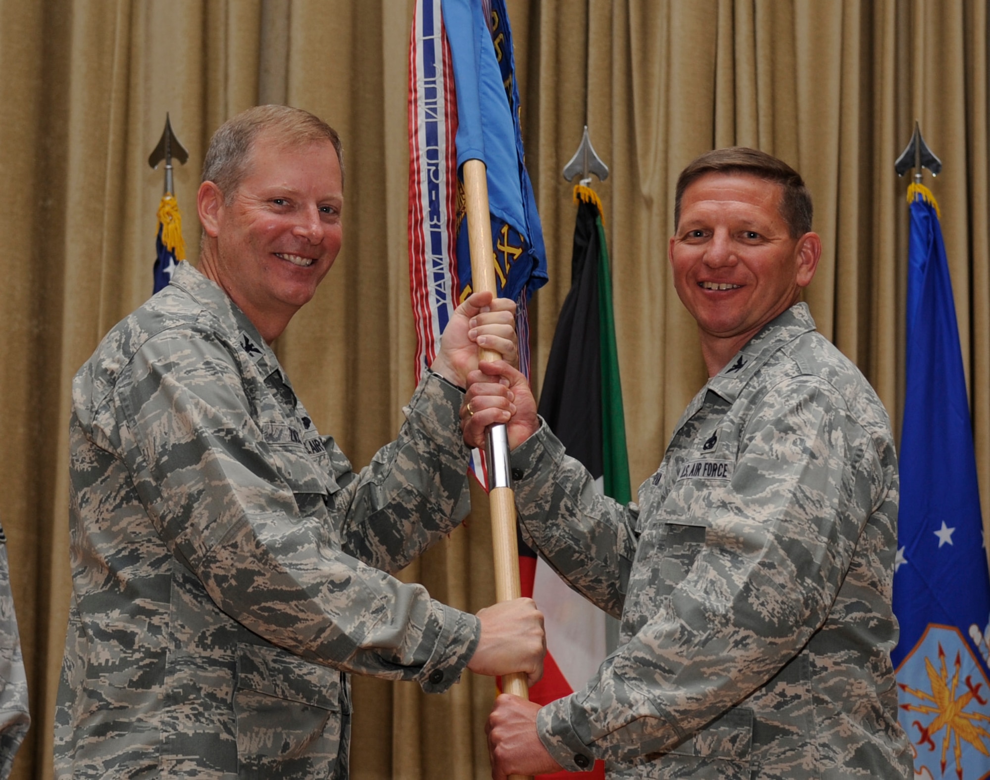 SOUTHWEST ASIA - Col. Michael Zick, 386th Air Expeditionary Wing commander, gives the 386th Expeditionary Maintenance Group guideon to Col. John Migyanko, the new 386th EMXG commander, during a change of command ceremony here June 14, 2012.  (U.S. Air Force photo/Staff Sgt. Alexandra M. Boutte)
