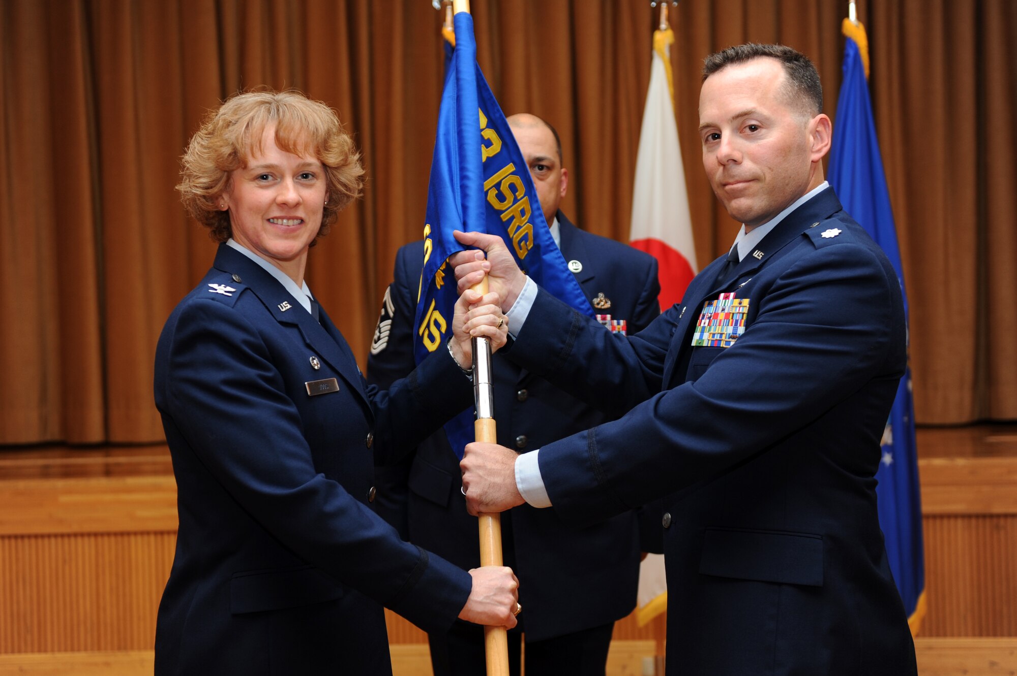Lt. Col. Eric Monico, right, 301st Intelligence Squadron commander, assumes command of the 301st Intelligence Squadron from Col. Kimberlee Joos, 373rd Intelligence, Reconnaissance and Surveillance Group commander, during a change of command ceremony at Misawa Air Base, Japan, June 14, 2012. Monico is coming from a Data Masked Unit as the Director of Operations. (U.S. Air Force photo by Airman 1st Class Kia Atkins/Released)