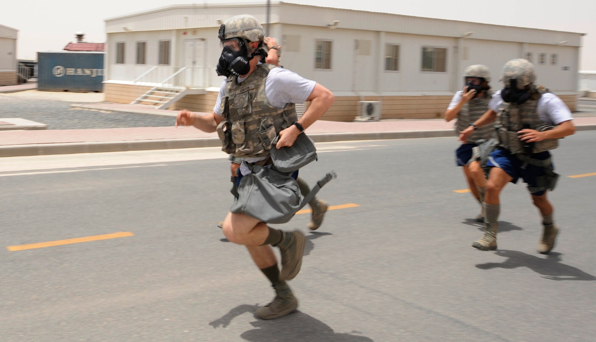 SOUTHWEST ASIA – Members of the 387th Expeditionary Security Forces Squadron race to get geared up during the first Defender Challenge here June 9, 2012. Each member raced to their gear, put it on with their gas masks and ran to the finish line. Each team was timed during the task. (U.S. Air Force photo/Staff Sgt. Alexandra M. Boutte) 