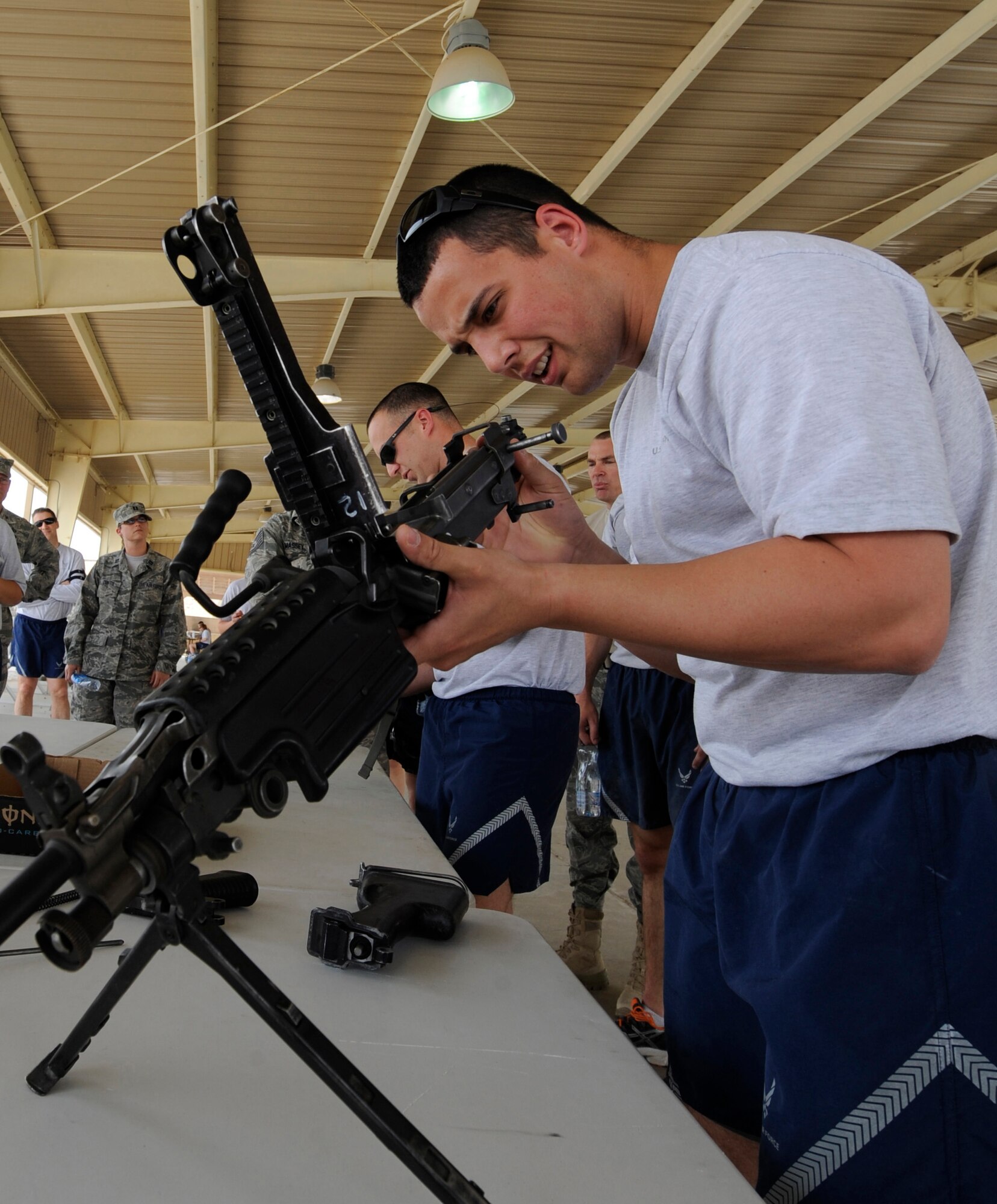 SOUTHWEST ASIA – A member from the 386th Expeditionary Security Forces Squadron assembles a weapon during the first Defender Challenge June 9, 2012. During this event, the team was given a bucket filled with four field-stripped weapons and was timed to reassemble an M-9, M-16A, M-249 and M-240 weapon. The team reassembled all weapons in 2:04. (U.S. Air Force photo/Staff Sgt. Alexandra M. Boutte) 