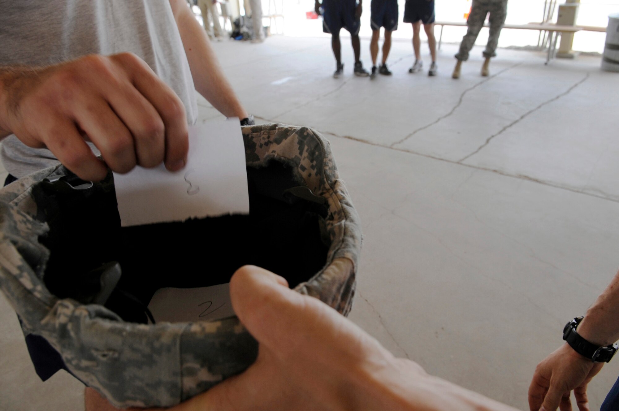 SOUTHWEST ASIA – Each fire team captain drew a number for fair placement during the first Defender Challenge here June 9, 2012. Seven four-person teams performed five tasks consisting of four-man buddy push-ups, mental and physical challenge, weapon assembly, down driver/gunner, and gear relay.   (U.S. Air Force photo/Staff Sgt. Alexandra M. Boutte) 