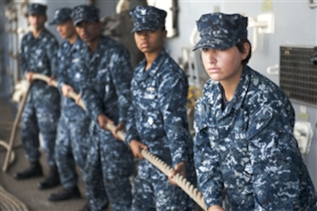 Sailors handle a mooring line aboard the USS Pearl Harbor (LSD 52) as the ship moors to a pier in Pearl Harbor, Hawaii, on June 13, 2012.  The amphibious dock landing ship and embarked Marines from the 11th Marine Expeditionary Unit are deployed conducting operations in the 3rd Fleet area of responsibility as part of the Makin Island Amphibious Ready Group.  