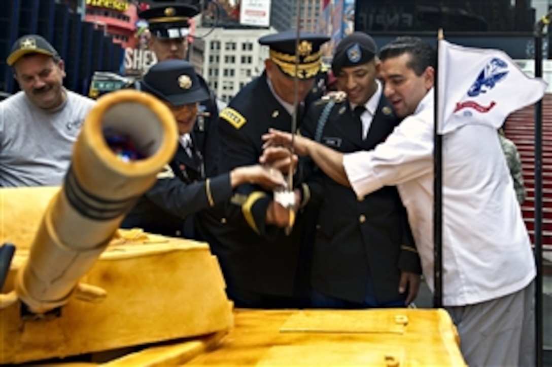 Army Chief of Staff Gen. Ray Odierno is joined by both the youngest and oldest soldiers in the crowd as well as Buddy Valastro from the television show "Cake Boss" as they cut the cake made to honor the U.S. Army’s 237th birthday at Times Square in New York, June 14, 2012.