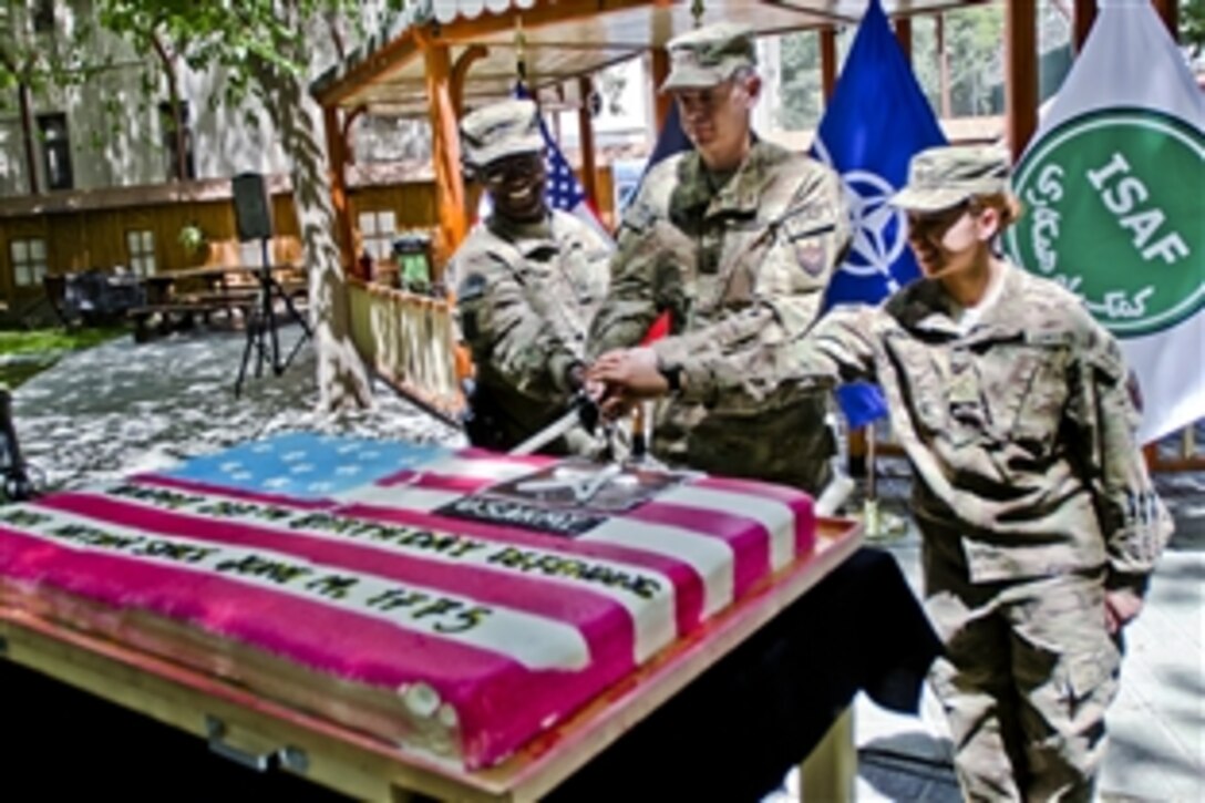 U.S. Army service members cut a cake during a ceremony commemorating the U.S. Army's 237th birthday at the International Security Assistance Force headquarters in Kabul, Afghanistan, June 14, 2012.