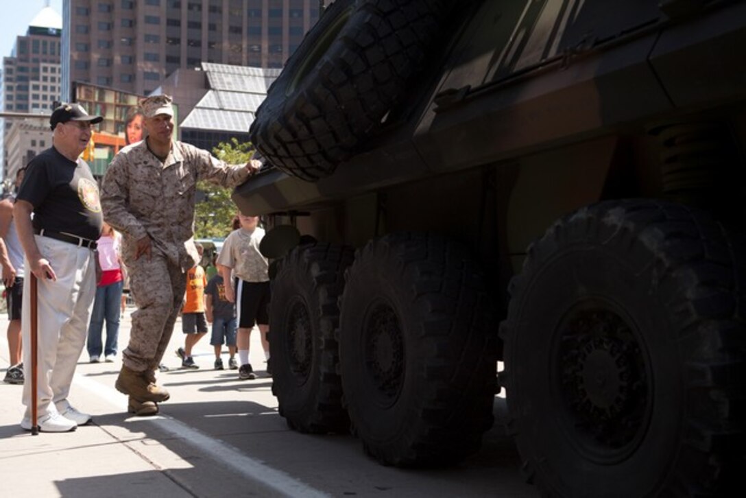 Sgt. Joshua Davis, vehicle commander with 2nd Light Armored Reconnaissance Battalion, and native of Auburn, Maine, explains the light armored vehicle to Vietnam War veteran Lawrence Catch in Public Square in downtown Cleveland June 14, 2012. Catch, who served from 1951-1953, said he enjoyed seeing all the advances in technology since he served. â??I wish we had some of these things when I was in,â? Catch said. â??We could have used them.â? More than 750 Marines will be in Cleveland until June 17 displaying Marine aircraft, vehicles and equipment, as well as interacting and sharing with the public the values and character of the Marine Corps. One of the culminating events will be a Marine Air Ground Task Force demonstration, which showcases Marinesâ?? ability to assault from ship-to-shore via ground and air, June 16-17 at Burke Lakefront Airport. (U.S. Marine Corps photo by Cpl. Chelsea Flowers)