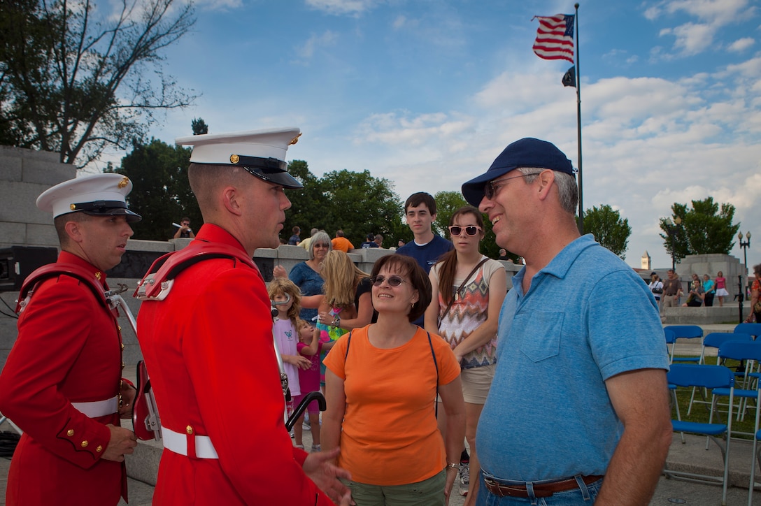 Sgt. Trevor Solberg, a U.S. Marine Drum & Bugle Corps drummer, center, speaks with guests at the conclusion of the inaugural performance of the Friends of the National War World II Memorial 2012 Concert Series at the WWII Memorial in Washington, D.C., June 14. The free concert coincided with the National Flag Day and the U.S. Army's birthday. The D&B closed its concert by playing "Armed Forces Salute," a medley of each branch of service song.