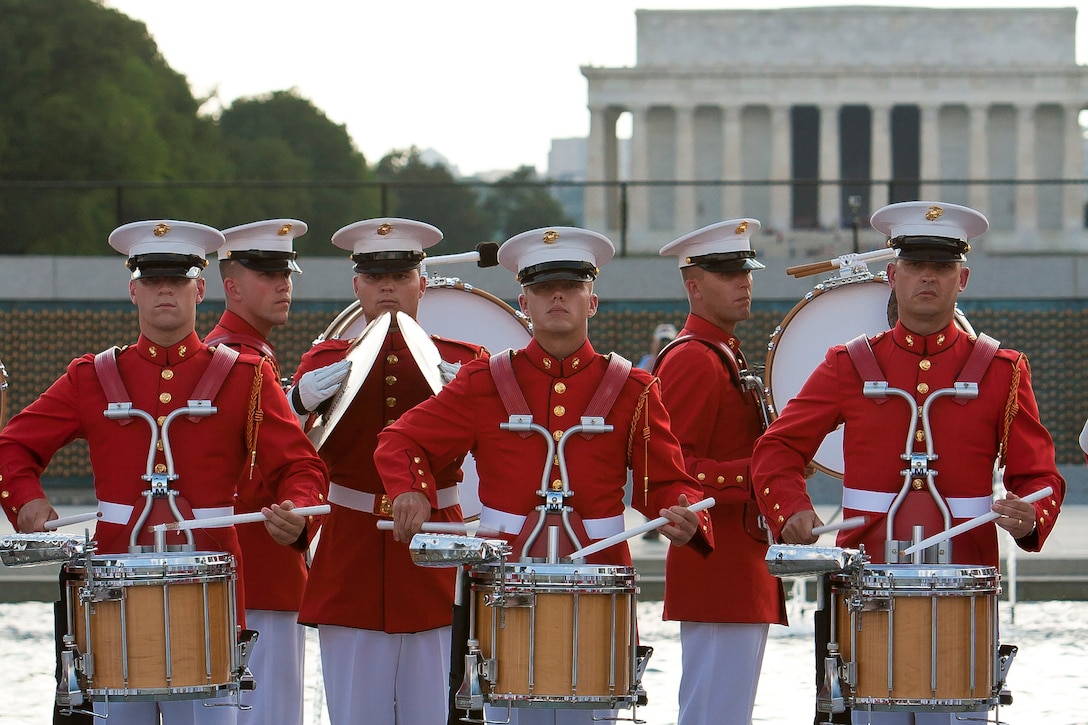 U.S. Marine Drum & Bugle Corps Marines perform during the inaugural performance of the Friends of the National War World II Memorial 2012 Concert Series at the WWII Memorial in Washington, D.C., June 14. The free concert coincided with the National Flag Day and the U.S. Army 237th birthday. The D&B closed its concert by playing "Armed Forces Salute," a medley of each branch of service song.