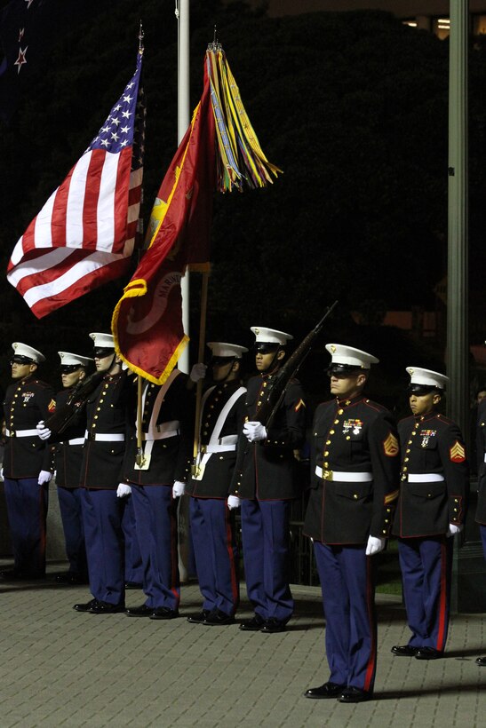 United States Marines with Marine Forces Pacific and 11th Marine Regiment stand at attention during the sunset ceremony at the Parliament House here, June 14. Government and military officials of the United States and New Zealand commemorated the 70th anniversary of the arrival of U.S. forces in Wellington during World War II. Australian and New Zealand forces were conducting heavy fighting in Northern Africa in 1942 while U.S. forces played a significant role in the defense of Oceania.::r::::n::(U.S. Marine Corps photo by Sgt. Jacob H. Harrer)::r::::n::