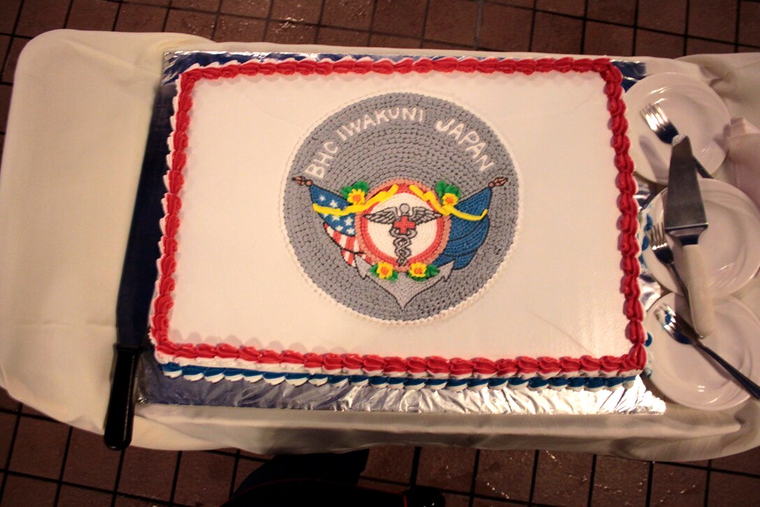 he ceremonial Navy Corpsman cake awaits the cake cutting ceremony while corpsmen enjoy the celebrations during the Corpsman Ball in the Club Iwakuni Ballroom here June 15, 2012. The Corpsman Ball celebrates the hard work and dedication Navy Corpsman display daily by keeping military members healthy and helping to ensure the military is always mission capable.