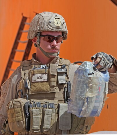 Rising seventh-grader, Sam, rotates the testing wheel, increasing force through until tower failure. During Quantico’s Science, Technology, Engineering and Mathematics Academy students were challenged to construct the lightest tower that can support the most weight possible. The tower displayed here, weighed 38 grams and supported 107 kilograms of pressure before collapsing.