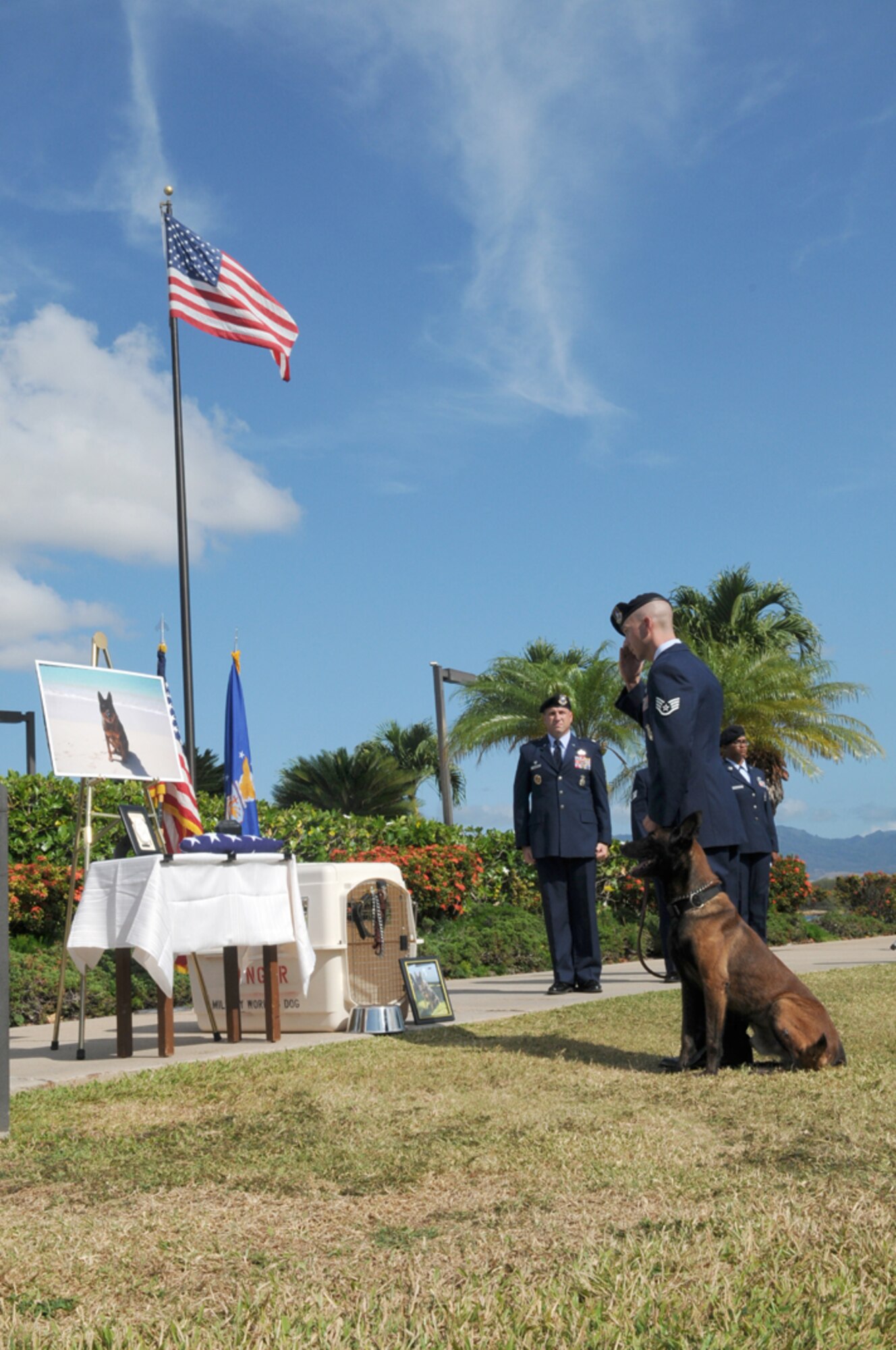 Staff Sgt. Ricky Renfroe, 6547th Security Forces Squadron military working dog handler, and Jimmy, honor Military Working Dog Bert during a memorial ceremony June 13, 2012, at the Missing Man Memorial, Joint Base Pearl Harbor-Hickam, Hawaii. Bert died May 25 due to complications of a tumor found on his heart. (U.S. Navy photo/Dave Underwood)