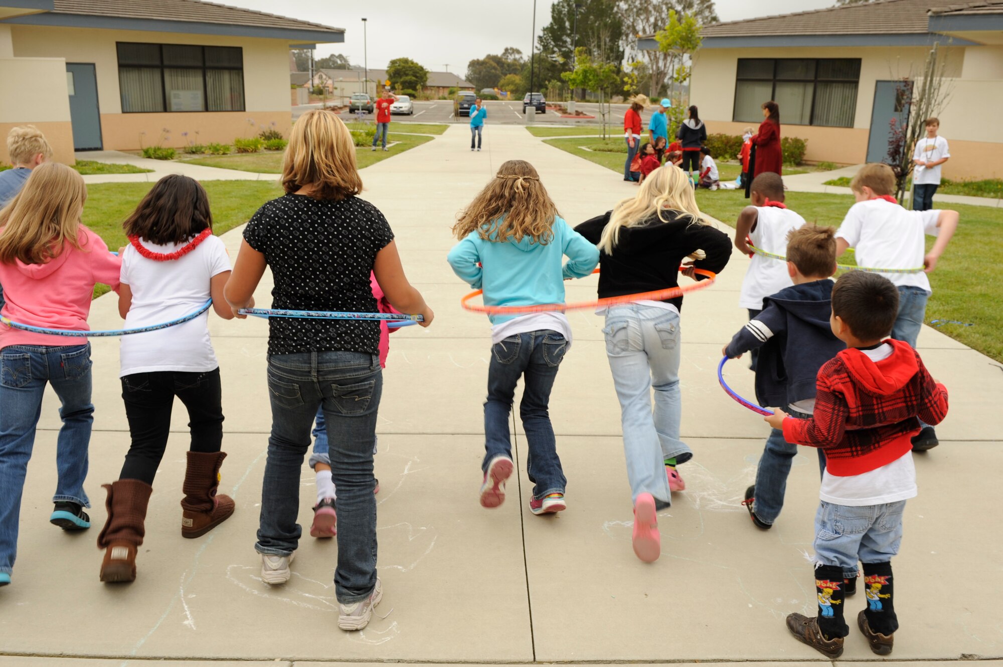 VANDENBERG AIR FORCE BASE, Calif. -- Children run in a hula-hoop race at Vacation Bible School hosted by the 30th Space Wing Chapel staff here Friday, June 15, 2012. The school is in their tenth year of operation, teaching 140 students in five different classes with the help of more than 50 base volunteers. (U.S. Air Force photo/Staff Sgt. Levi Riendeau)