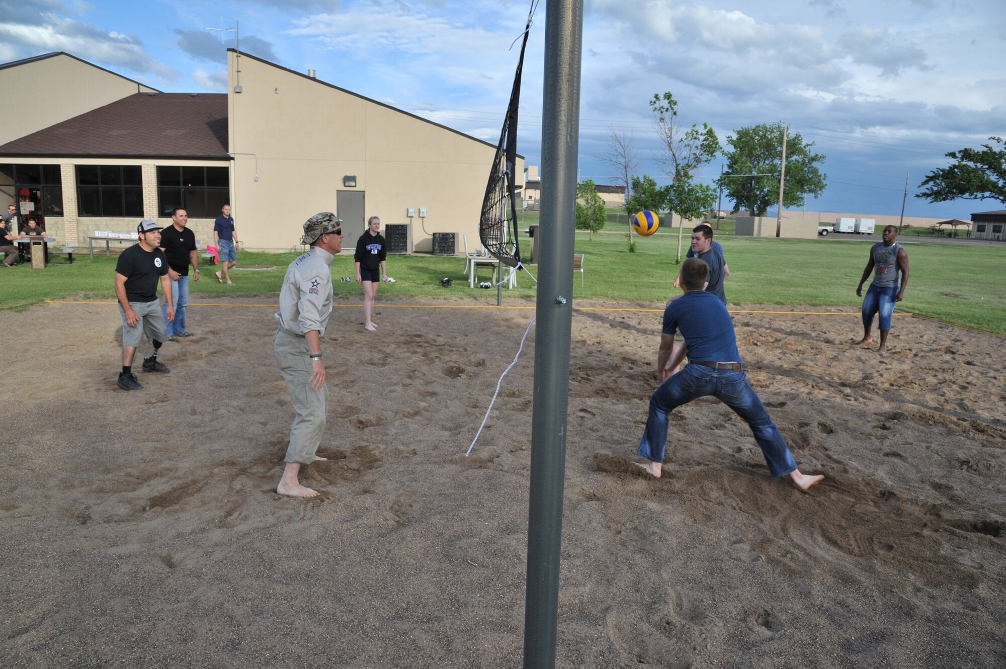 Members of the American300 Baja 1000 Tour participate in a game of volleyball with Malmstrom Airmen at the Detour June 12. The tour members enjoyed a pizza dinner while interacting with the Airmen at the facility specifically designed for their use. (U.S. Air Force photo/John Turner)