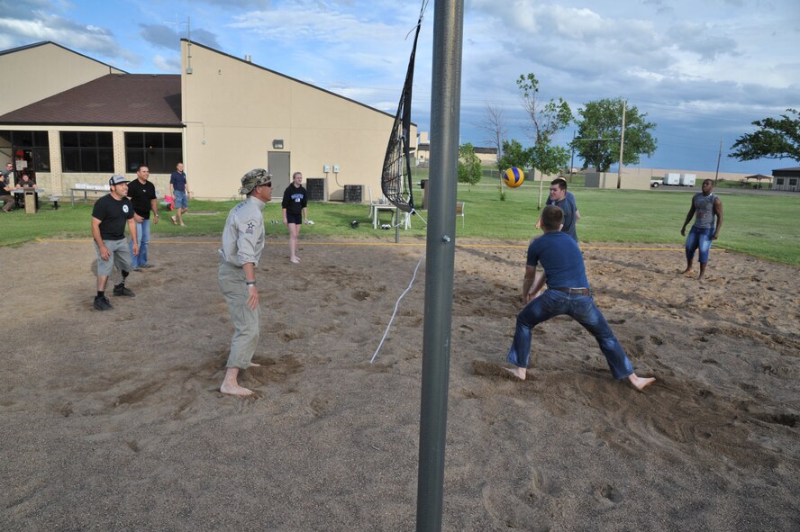 Members of the American300 Baja 1000 Tour participate in a game of volleyball with Malmstrom Airmen at the Detour June 12. The tour members enjoyed a pizza dinner while interacting with the Airmen at the facility specifically designed for their use. (U.S. Air Force photo/John Turner)
