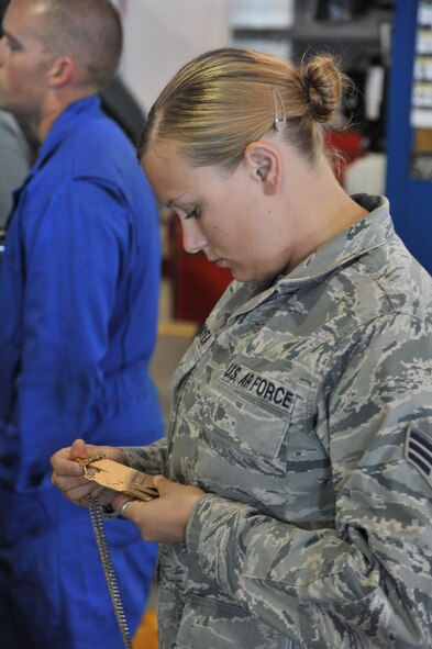 Senior Airman Danielle Bunyea, 341st Logistics Readiness Squadron vehicle management and analysis apprentice, looks at the gold medal Chris Ridgeway won at the Xgames in Los Angeles in the supercross adaptive competition. (U.S. Air Force photo/John Turner)