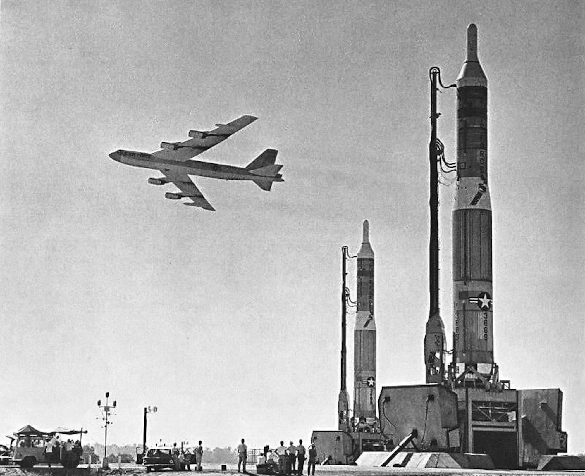 Two Titan I missiles stand ready to launch as a B-52 Stratofortress flies overhead. The Titan I missile was the first multi-stage intercontinental ballistic missile and was used as a nuclear deterrent during the early 1960's. (Historical Archives Official U.S. Air Force Photo)