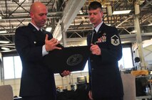 U.S. Air Force Capt. Robert Montgomery, 20th Component Maintenance Squadron accessories flight commander, and Master Sgt. Wesley Halleck, 20th Component Maintenance Squadron, read a certificate of appreciation for Air Force active duty service during Halleck’s retirement ceremony, Shaw Air Force Base, S.C. June 15, 2012. Retirees are presented with awards to show that their work and time in the military was appreciated and memorable. (U.S. Air Force photo by Airman 1st Class Ashley L. Gardner/ Released)