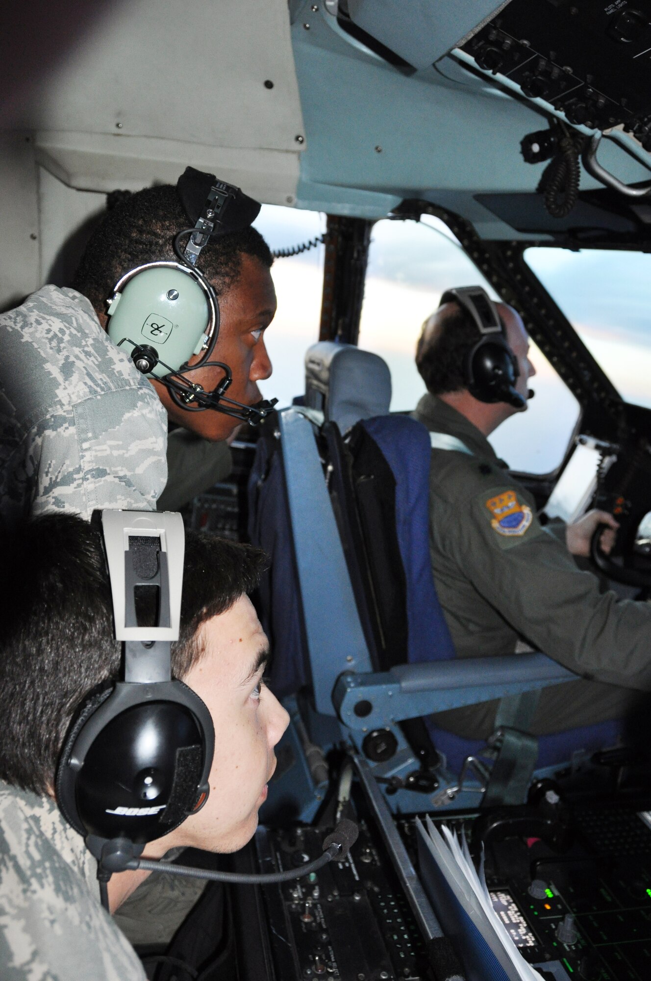 Air Force Academy Cadets, Second Class Anthony Wooding Jr. (left top) and Adam N. Krause observe Lt. Col. Thomas K. Smith Jr., pilot a C-5A Galaxy  during an aerial refueling mission over Kansas. An aircrew from the 433rd Airlift Wing took 12 cadets on an orientation flight to familiarize them with the capabllities of the aircraft and to explain their experiences one on the the largest aircraft in the Air Force. (U.S. Air Force photo/ Tech. Sgt. Carlos J. Trevino) 