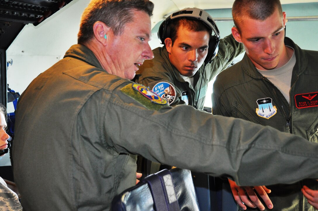 Master Sgt. Joe Shepard (left) a flight engineer with the 68th Airlift Squadron, Joint Base San Antonio - Lackland Air Force Base explains an instrument panel to Air Force Academy Cadets Second Class Terry Tilghman and Ryan J. Gourley during an orientation flight on board the C-5A Galaxy aircraft. The cadets observed an aerial refueling mission during the orientation flight (U.S. Air Force photo/ Tech. Sgt. Carlos J. Trevino) 