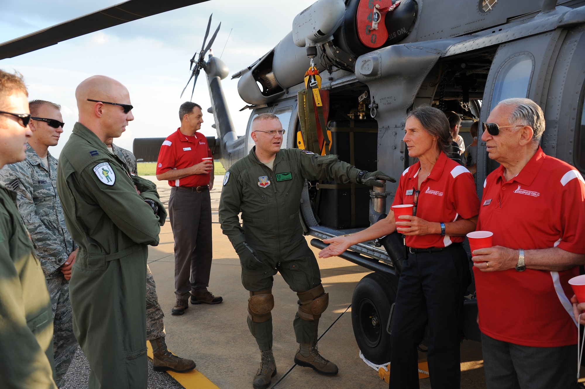 Retired U.S. Army Brig. Gen. Rhonda Cornum (second from right) speaks to members of the Moody Air Force Base 41st Rescue Squadron standing alongside their HH-60G Pavehawk combat search and rescue helicopter June 8 during Air Command and Staff College's Gathering of the Eagles event. Cornum, who was a prisoner of war during the Gulf War, was one of 14 featured guests in the ACSC program that promotes distinguished aviators as part of an air power legacy elective. Cornum's husband Kory (red shirt middle) looks at the Pavehawk. Pictured beside Cornum is Dr. Mudhafar Kaboush (right). Cornum's arms were broken during a helicopter crash before she was captured. Kaboush is the Iraqi surgeon who provided medical care to Cornum during her captivity. Kabousch was Cornum's special guest for the GOE activities last week. It was the first time their paths have crossed again since she was a POW. He now lives in California.  (U.S. Air Force photo by Wendy Simonds)