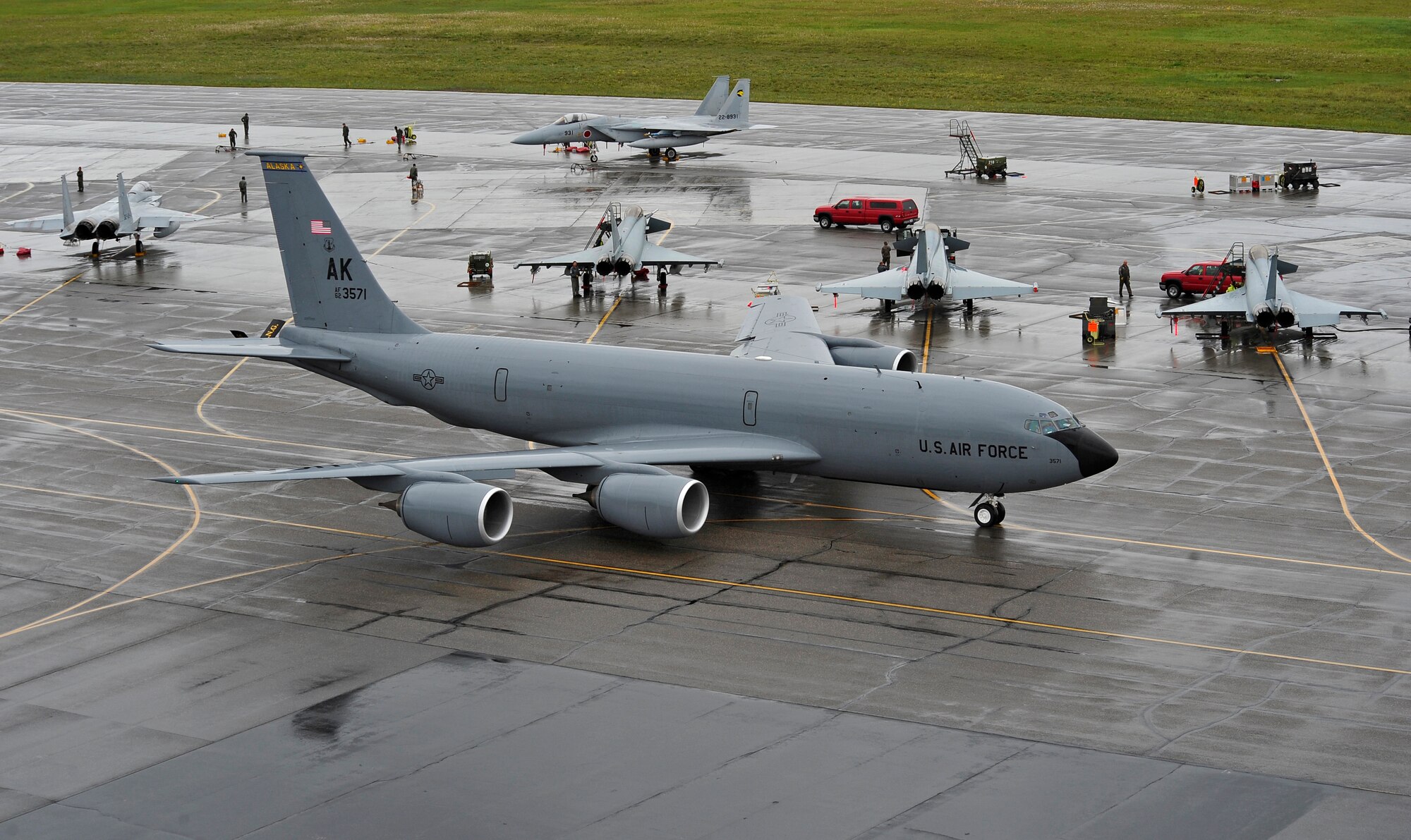 A KC-135R Stratotanker taxis past German air force Eurofighter Typhoons and Japanese Self Defense Force F-15J Eagles prior to take-off during RED FLAG-Alaska 12-2 June 13, 2012, Eielson Air Force Base, Alaska.  The support of the Stratotanker provides U.S. and coalition forces aircraft with the fuel it needs to execute the mission.  The Stratotanker is assigned to the 168th Air Refueling Wing, Eielson Air Force Base, Alaska.  (U.S. Air Force photo/Staff Sgt. Miguel Lara III