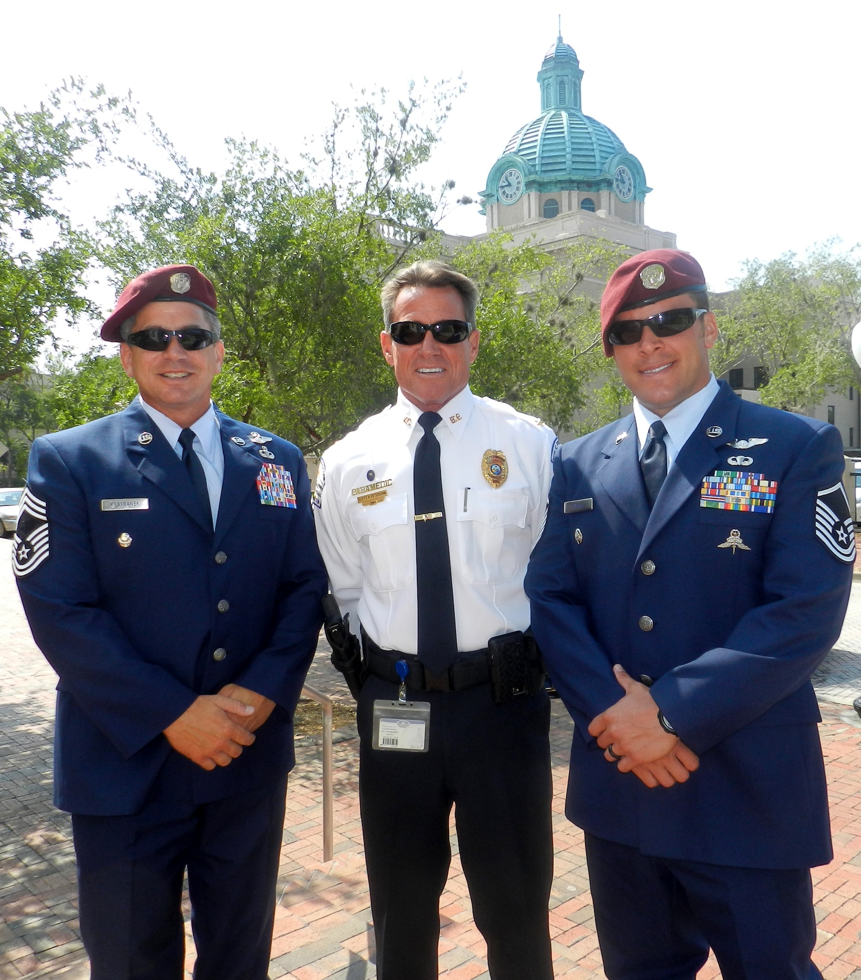 Air Force Reservists Chief Master Sgt. Doug Kestranek (left) and Master Sgt. Joe Traska (right), pararescueman, 920th Rescue Wing, Patrick Air Force Base, Fla., pose with Capt. Scott Petersohn, Volusia County Beach Patrol Deputy Chief, June 14, Flag Day, after Petersohn accepted a Patriot Award from them for his flexibility and support for Traska's employment with the county as a beach patrol officer. (U.S. Air Force photo/Capt. Cathleen Snow)