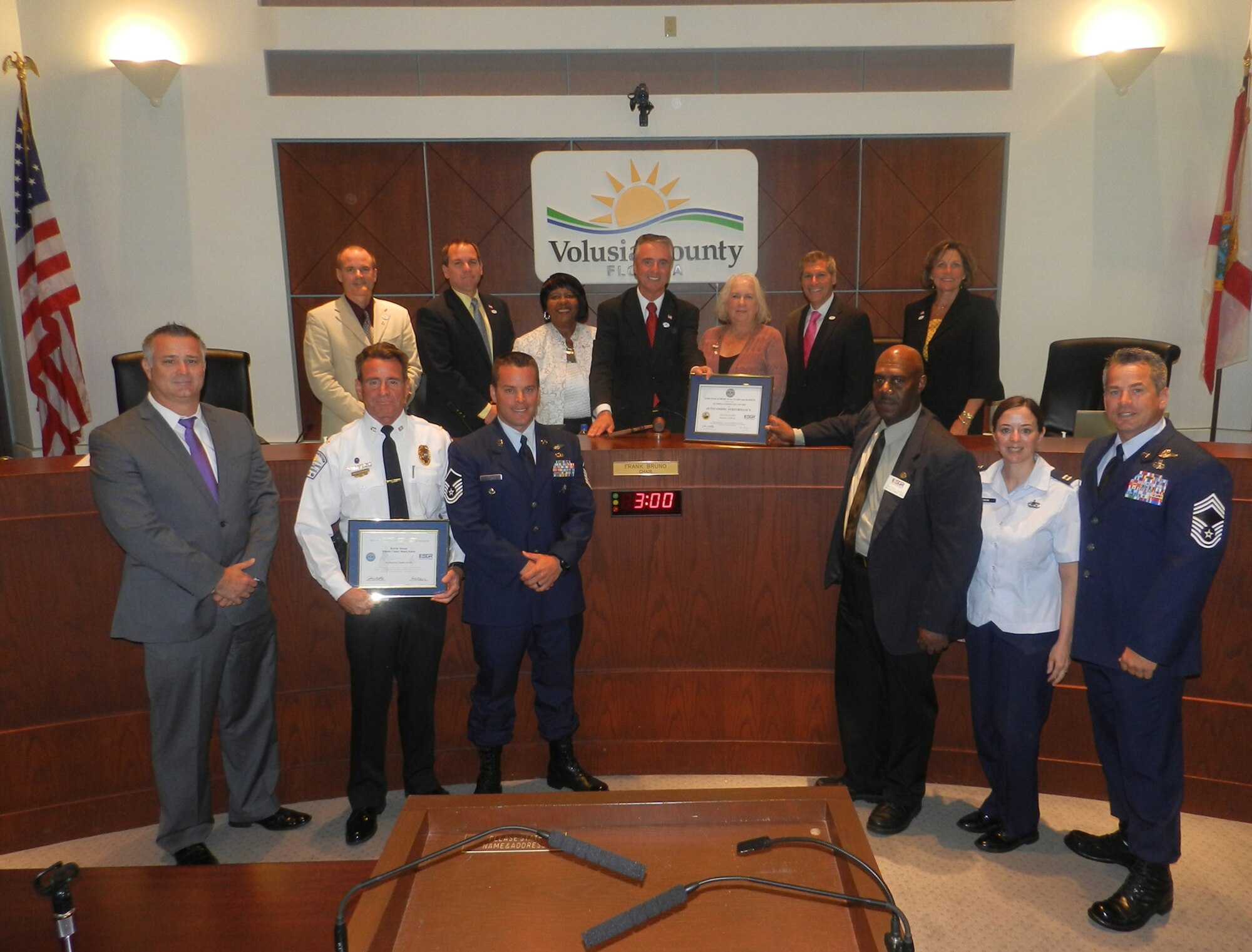 Air Force Reservists Master Sgt. Joe Traska and Chief Doug Kestranek, pararescuemen, 920th Rescue Wing, Patrick Air Force Base, and Mr. Garfield Jones, a DoD agency representative of the Employer Support of the Guard and Reserve (ESGR), presented Volusia County Beach Patrol with a Patriot Award for their flexibility and support for Traska's employment with the county as a beach patrol officer at the Volusia County Council meeting in Deland, Fla. June 14, Flag Day. (Courtesy photo)