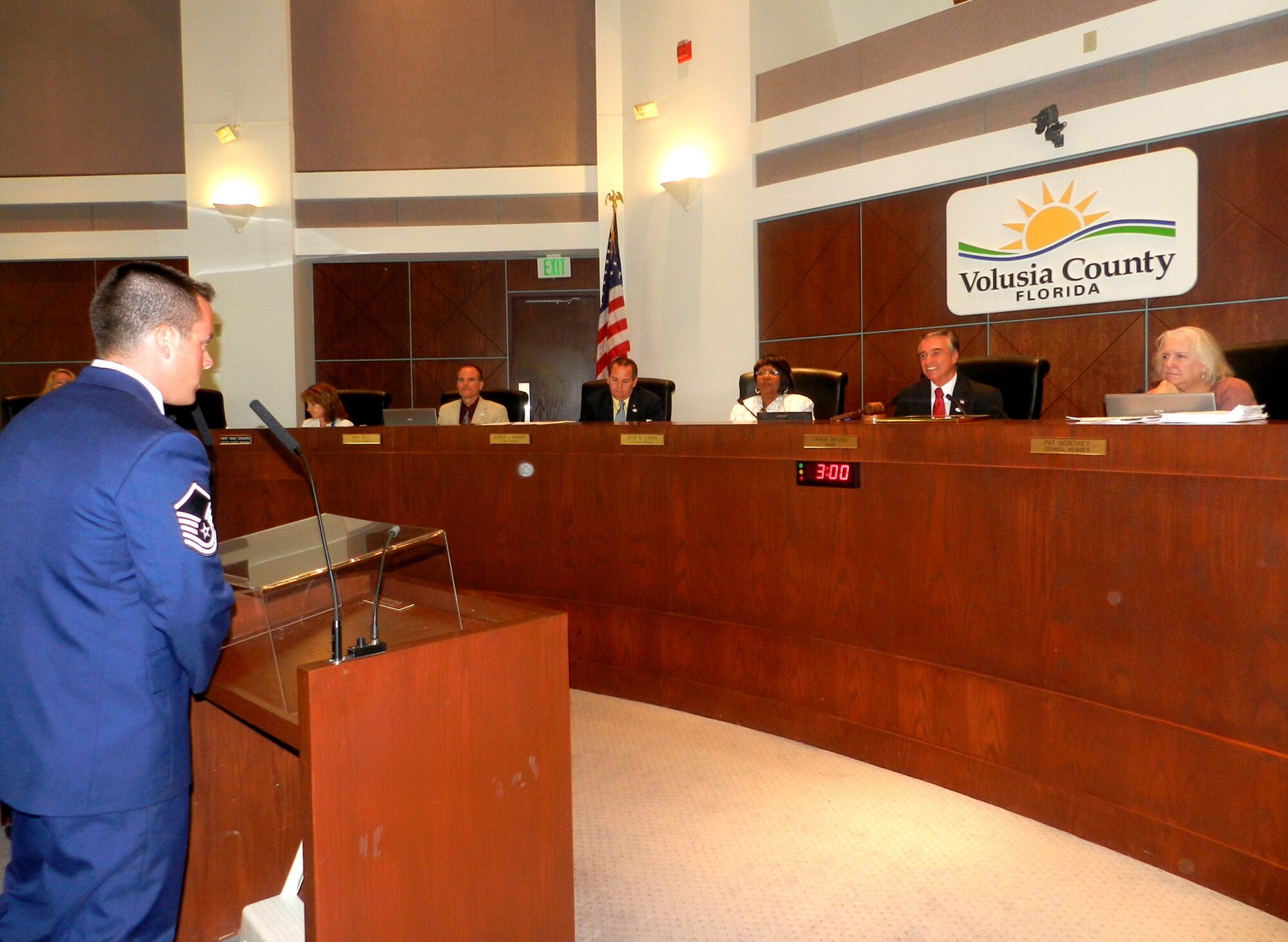 Master Sgt. Joe Traska, Air Force Reserve pararescueman, 920th Rescue Wing, Patrick Air Force Base, Fla., steps up to the podium June 14, Flag Day, to address the Volusia County Council in Deland, Fla. Traska, along with Chief Doug Kestranek, pararescue superintendent, 920th RQW, and Mr. Garfield Jones, a DoD agency representative of the Employer Support of the Guard and Reserve (ESGR), presented Volusia County Beach Patrol with a Patriot Award for their flexibility and support for Traska's employment with the county as a beach patrol officer. (U.S. Air Force photo/Capt. Cathleen Snow)