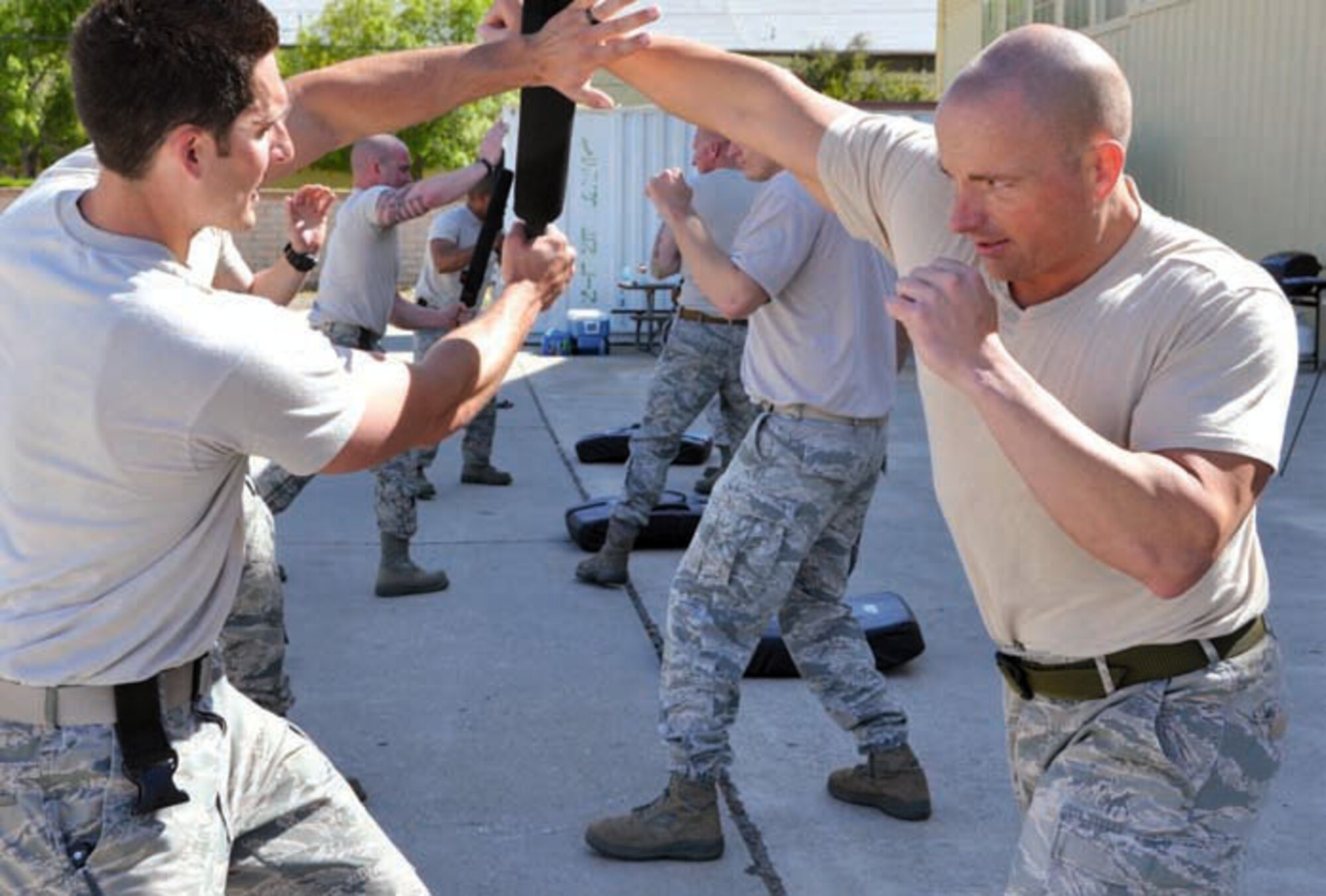 Staff Sgt. Joseph Gross (left) employs defensive techniques by using a baton to deflect Tech. Sgt. Michael Hammer's (right) aggressive attack. Ravens are trained in various protective disciplines such as verbal judo and unarmed self-defense such as Krav Maga and ground fighting. (U.S. Air Force photos BY Staff Sgt. Megan Crusher)