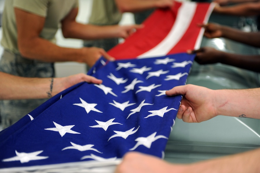 Airmen demonstrate flag folding for a funeral at Moody Air Force Base, Ga., June 14, 2012. The Moody Base Honor Guard is responsible for providing military funeral honors and military ceremonial support throughout South Georgia and North Florida. (U.S. Air Force photo by Staff Sgt. Ciara Wymbs/Released) 