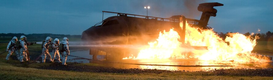 Firefighters from the 436th Civil Engineer Squadron extinguish a simulated airplane fire June 12, 2012 at Dover Air Force Base, Del. The members of the fire protection flight regularly train for real world emergencies.  (U.S. Air Force photo by Adrian R. Rowan)